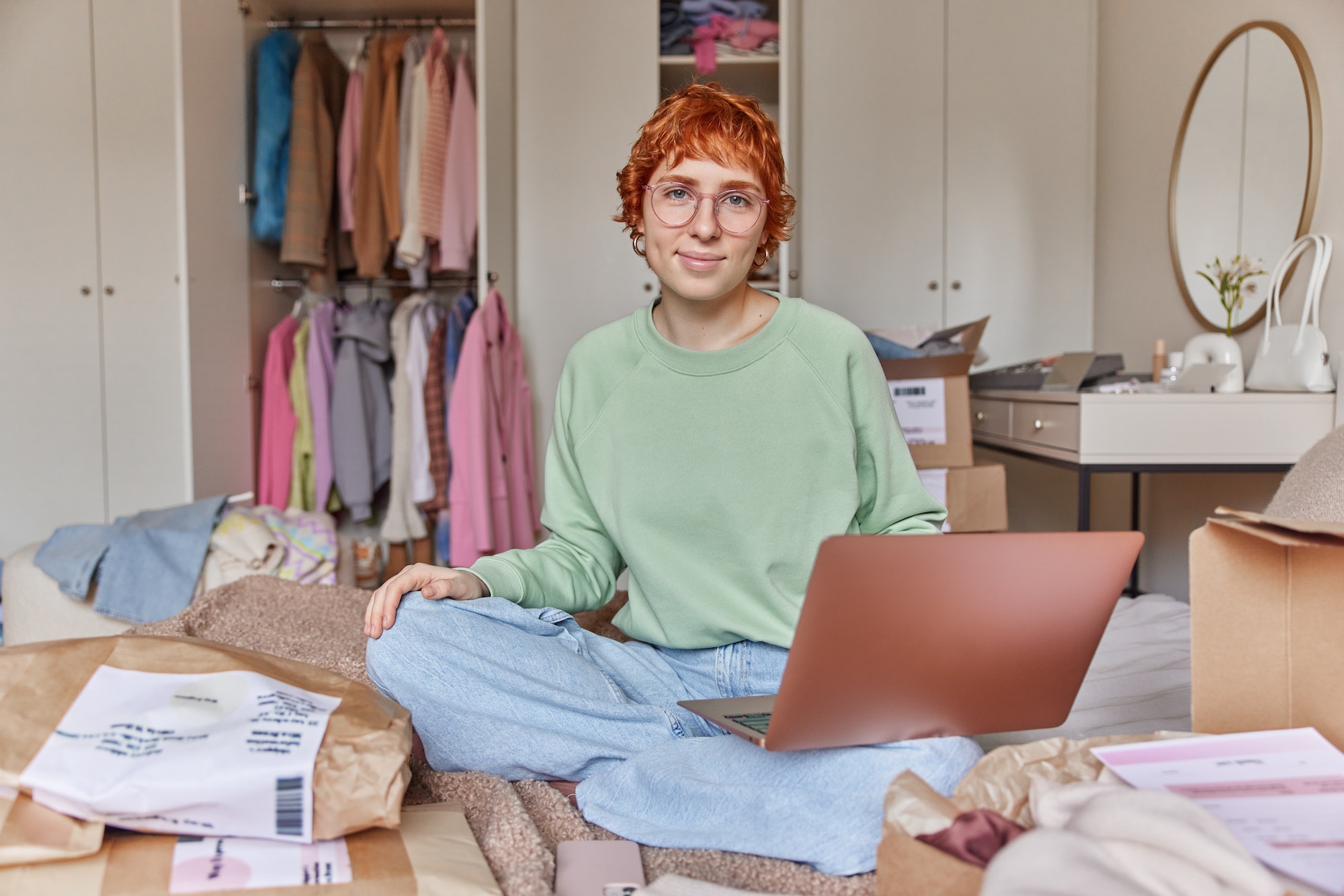 Online shopping concept. Young redhead woman workes online ecommerce shopping at home prepares